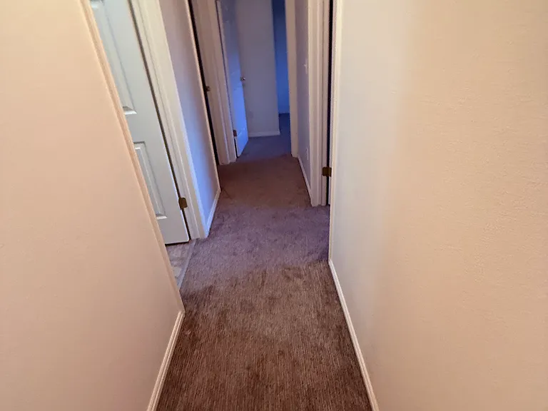 Upstairs hall. Smallest bedroom doorway at end, middle on right, bathroom and master on left.