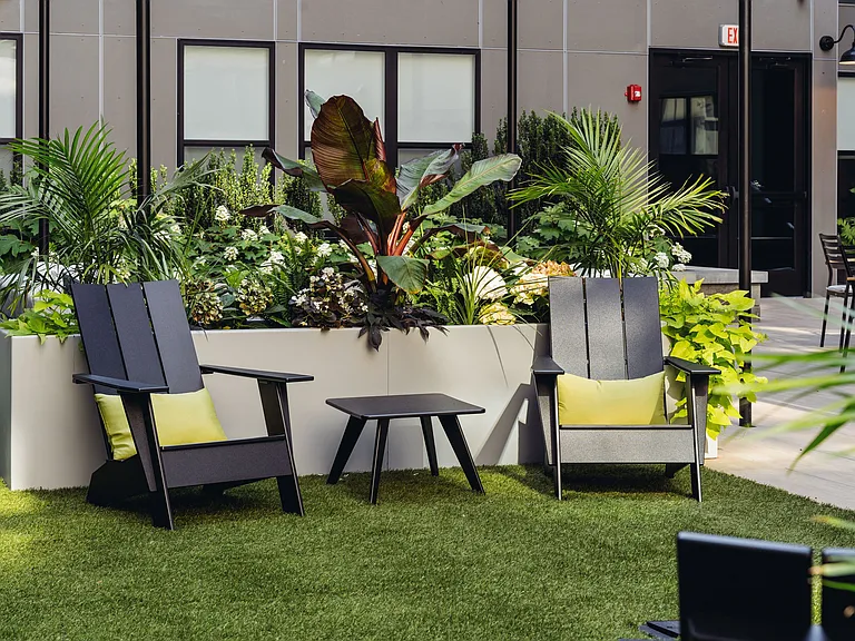 Central courtyard featuring lounge seating, bar area, outdoor tv's, and grills