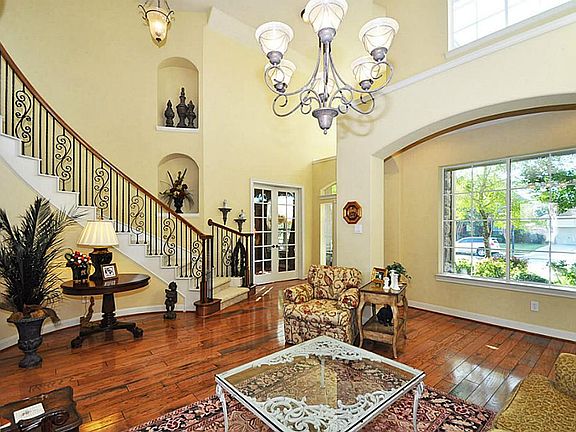 Looking back towards the entry of the home, the home offers architect features of art niches and plant/decor vignettes.