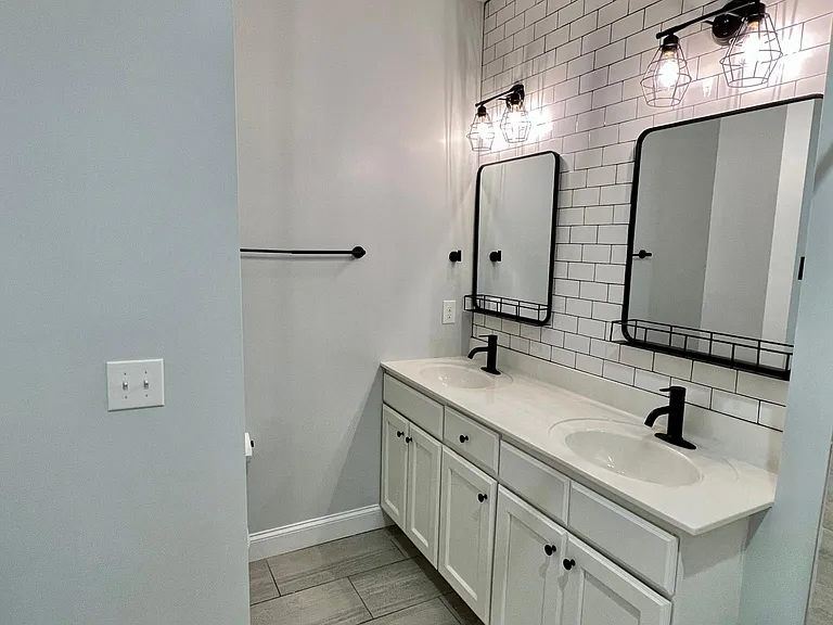 Upstairs master bedroom with walk-in closet and full bath featuring dual vanities.