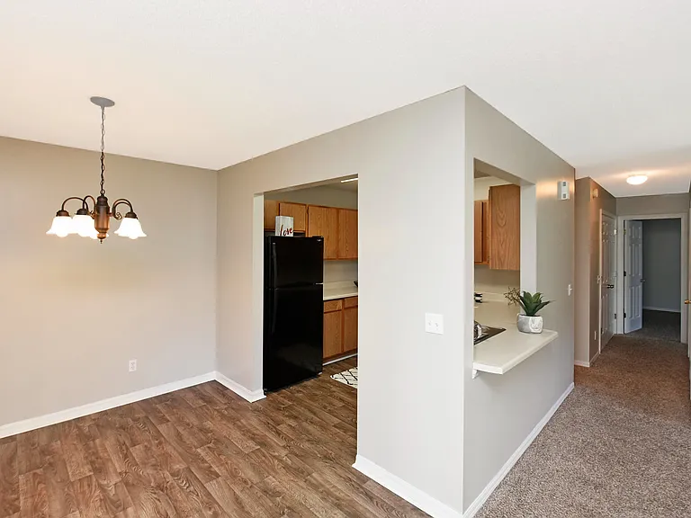 Explore this chic apartment interior, boasting a blend of contemporary kitchen design and inviting dining space.