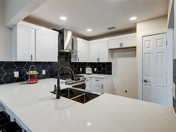 Fridge is not pictured here, but a full size stainless steel Kitchen Aid fridge is included!