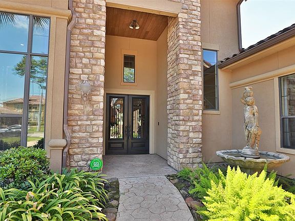 Approaching the front door you will see the lovely landscaping, beautiful stone elevation, and covered front porch!