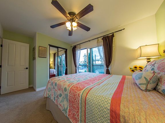 Queen bed in east-facing bedroom with fresh breezes!