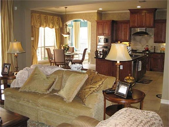 Spacious Family Room opens to Breakfast and Kitchen Area and views gorgeous Pool and Lake!  Tile Flooring! High Ceiling!