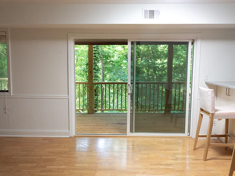 Now let's go out the screened sliding-glass door on the south side of the house and look at the large rear deck, which spans the entire length of the house.