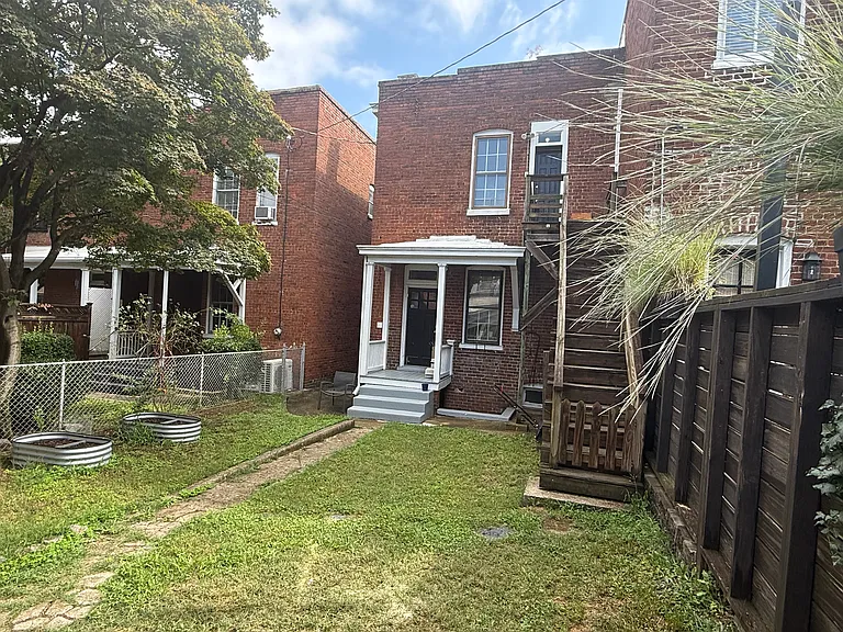 Fenced in backyard with basement storage access and an off street parking space.