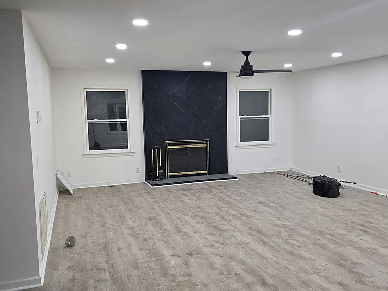 Living Room with updated fireplace, vinyl flooring, and lighting.