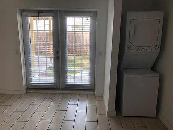 Inside view of front door entrance,1/2 the living area and stacked washer/dryer.