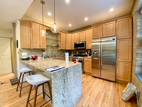 eat-in kitchen with waterfall edger counter and stainless steel appliances