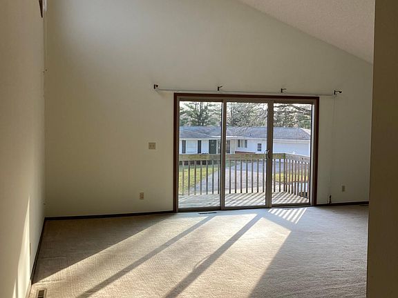 Living Room with vaulted ceiling and patio access.