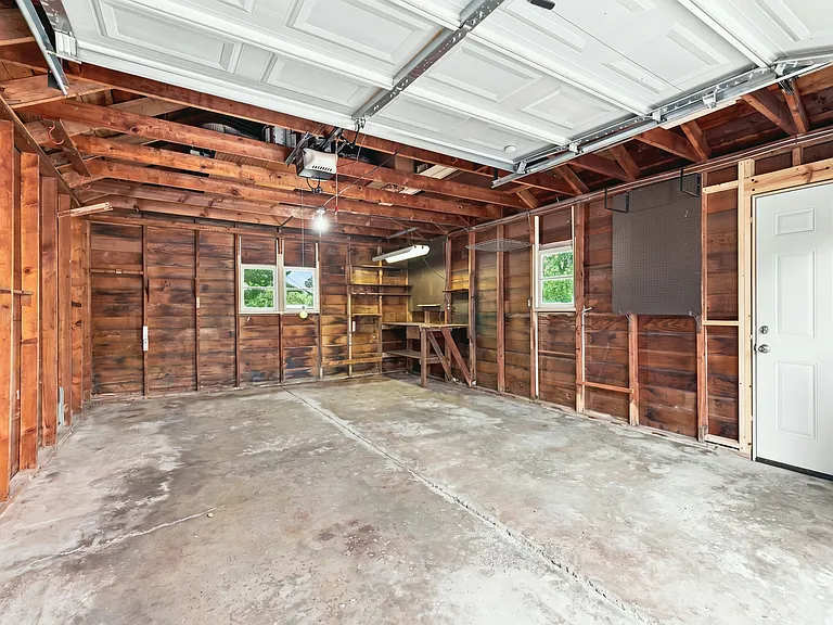 Oversized garage for your vehicles to keep them out of the elements. No car scraping in the winter, and no baking outside in the summer! Brand new man-door added. Automatic garage door opener with remote. Even has a work bench!
