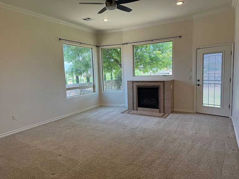 Primary bedroom with lots of natural light, gas fireplace, and outside entrance with added security door.