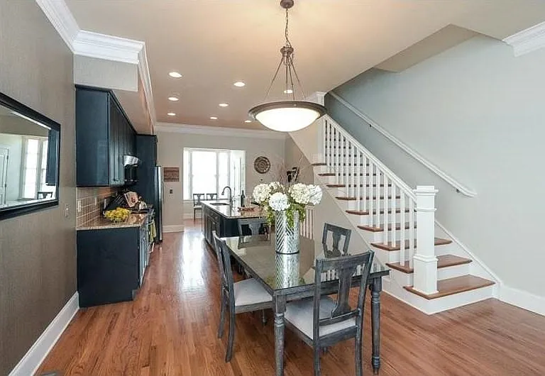 Dining and kitchen area featuring wood-finish flooring