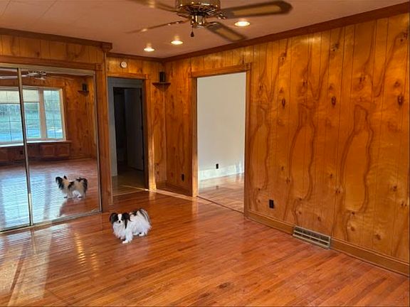 A wall of mirrors and lots of light. Warm paneling and hardwood floors.