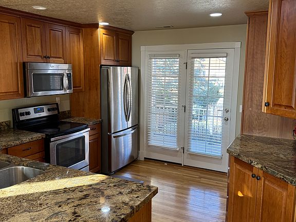 Upstairs kitchen featuring French doors that open onto the front patio