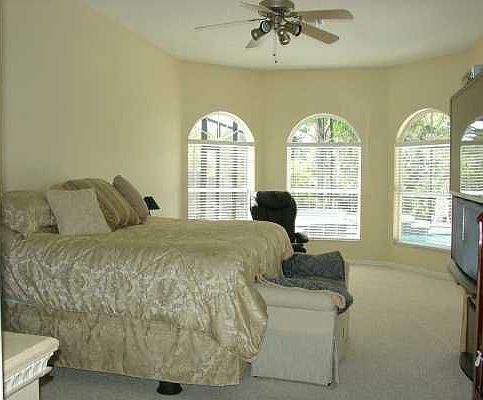 Large master with bay window type sitting area, sliding glass door to pool