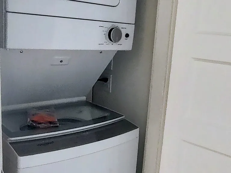The in-unit washer and dryer are located in a closet in the hallway immediately off the kitchen.