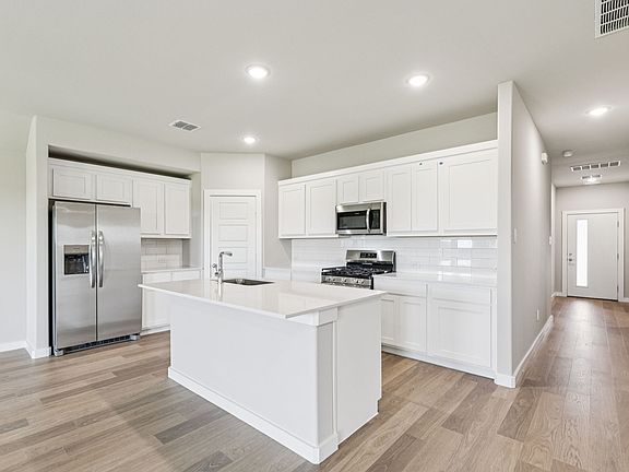 Kitchen in the Harper home plan by Trophy Signature Homes - REPRESENTATIVE PHOTO
