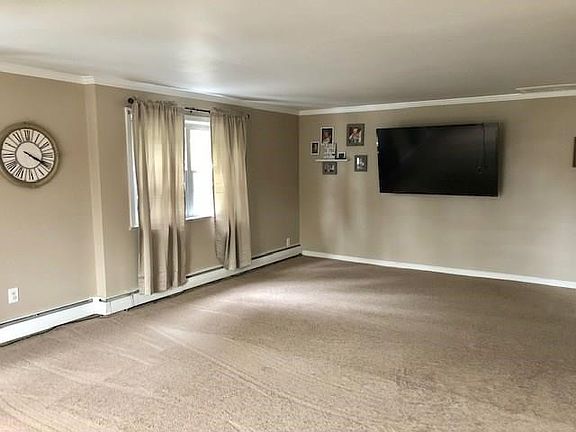 Huge Living Room featuring new carpeting.