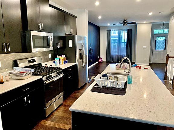 Modern upgraded kitchen with gourmet island and almost-new stainless steel appliances.