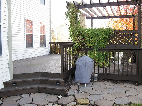 Large deck with separate firepit area under pergola, and paver area for grills
