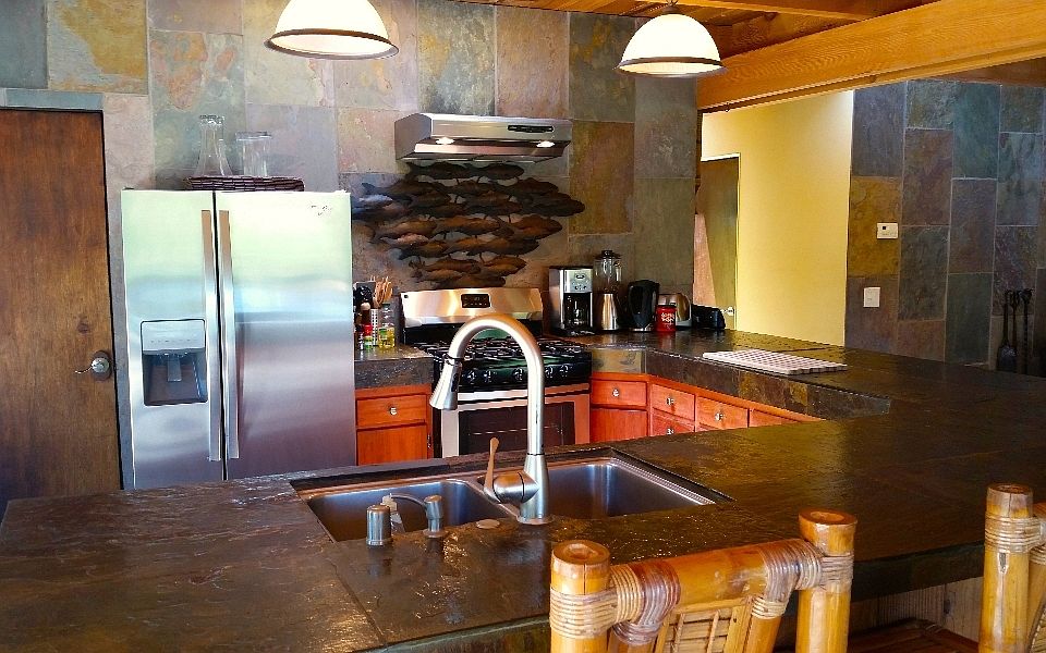 Kitchen pours into living and dining areas.