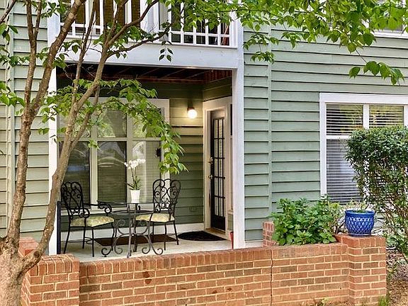 On level parking spaces back up to large patio and rear entrance door.