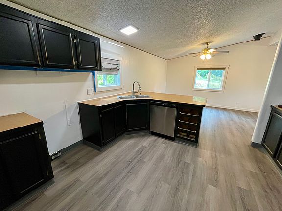 Kitchen has an oven/stove and dishwasher.