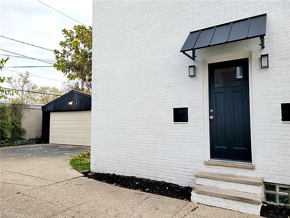Driveway wraps around to a spacious 2 car garage.