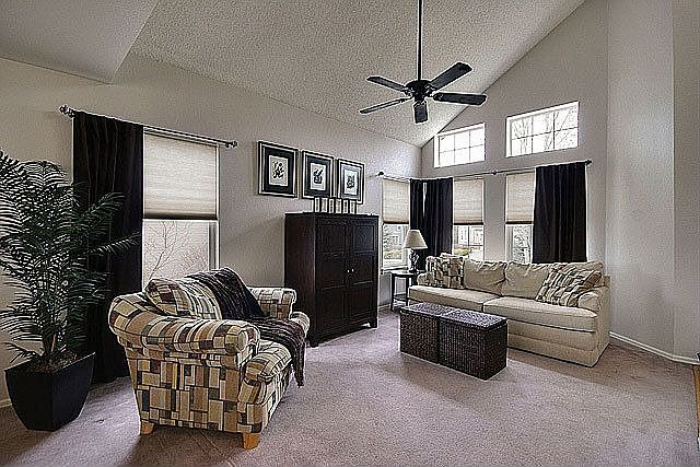 Formal liv rm w/ neutral carpet & vaulted ceilings.