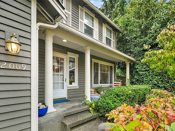 Large covered front porch. Mature landscaping, ornamentals.
