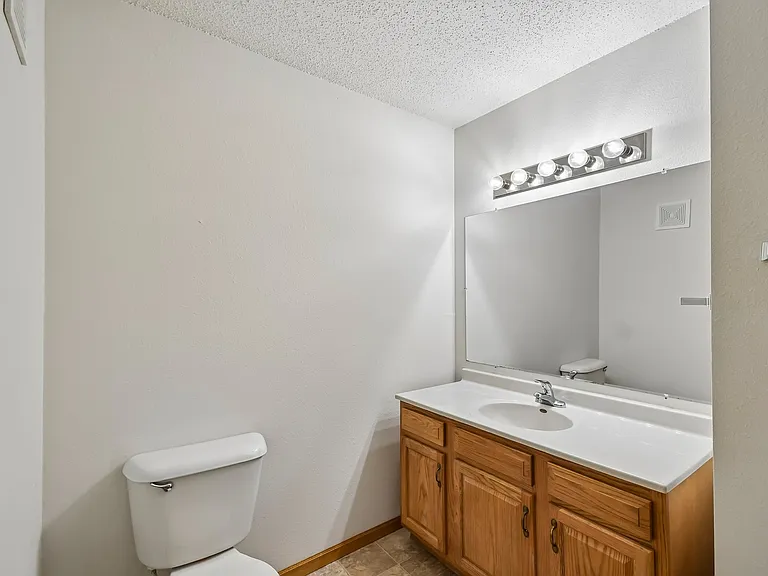 Step into modern comfort at Mill Pond Apartments. This spacious bathroom features ample natural light, sleek cabinetry, and ample counter space for all your essentials. Elevate your living experienceschedule a tour today!