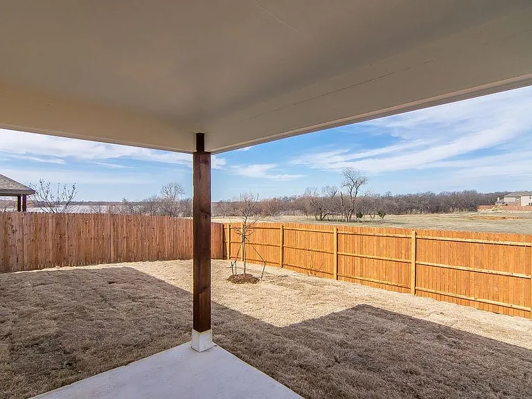 Backyard with covered patio.
