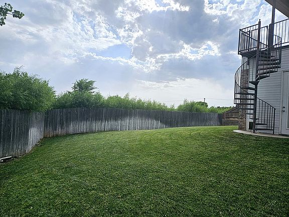 Large backyard with spiral staircase