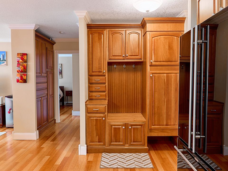 Welcoming entryway features custom wood cabinetry, offering both elegance and practical storage the moment you step inside