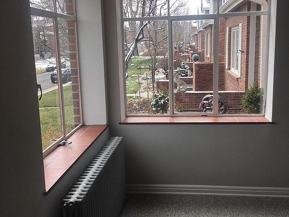 Corner windows brings in lots of light with views of mature trees and lawn from your bedroom.