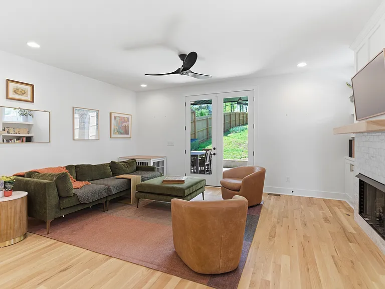 Relax in this inviting living room filled with natural light, featuring a cozy gas fireplace and plenty of space to unwind or entertain.