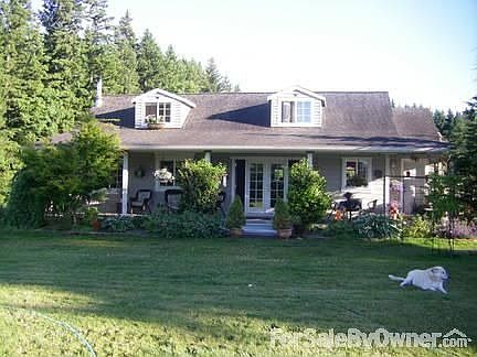 Front of house : Notice the front covered porch and ample landscaping