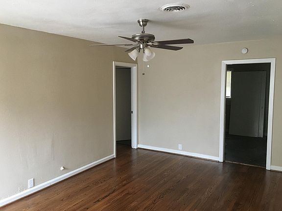 Original Living room with re-finished hard wood floors and new ceiling fan.
