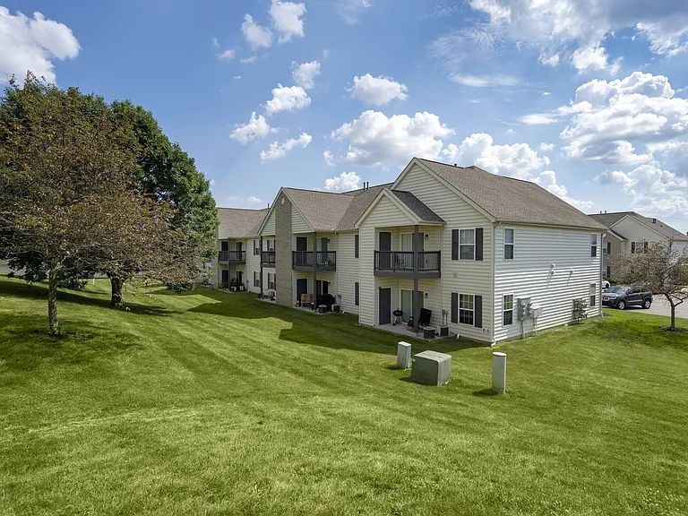 A beautiful home with a lush green lawn, offering a welcoming and picturesque exterior.