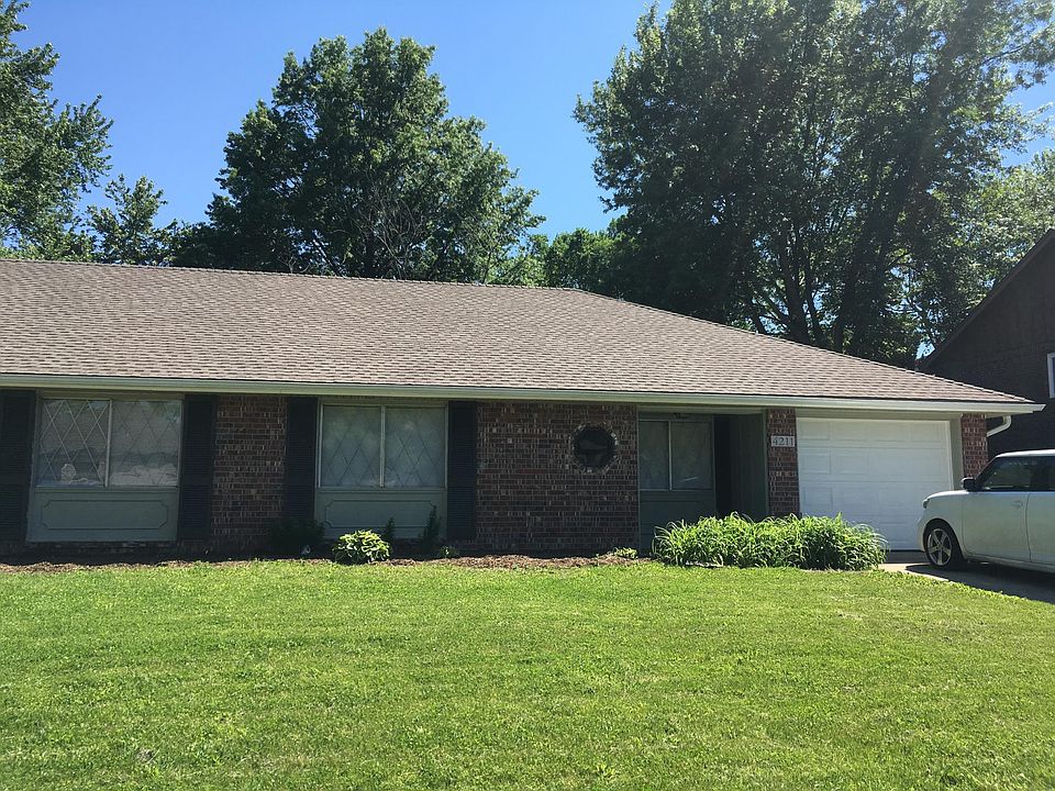 Exterior (driveway, garage, and patio and fenced yard in the back)