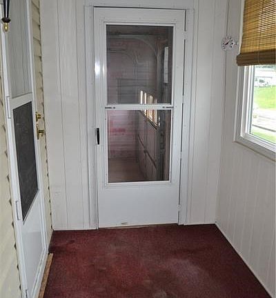 Enclosed front porch leading to garage and home.