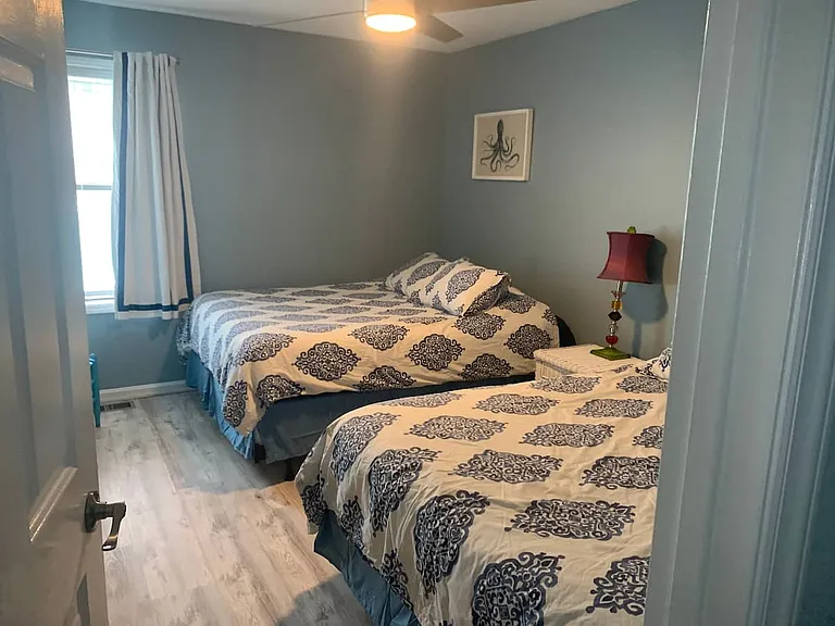 Guest bedroom with two queen beds and flat screen tv with cable and DVD player