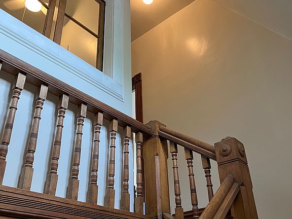Stairwell approaching apartment entrance.