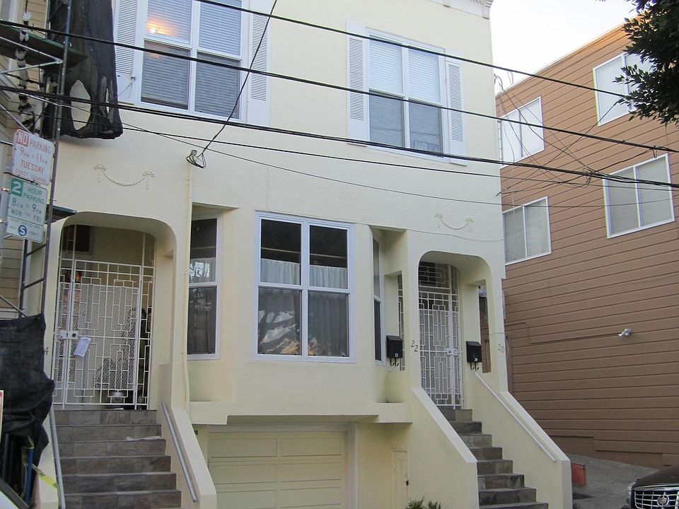 Exterior of 3-unit building, including 20 Pond Street.