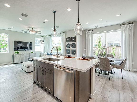 Kitchen features stainless appliances, quartz counters shaker style cabinets