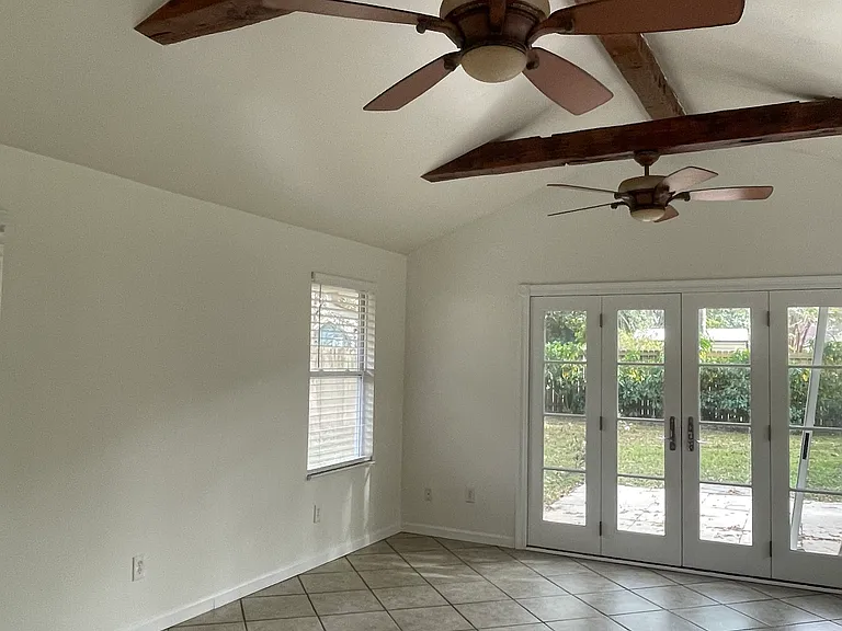 Lovely tile sunroom with ceiling fans, lots of light and tile floors