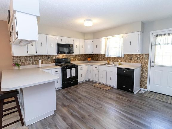 Huge kitchen with tons of cabinets, breakfast bar and new flooring!