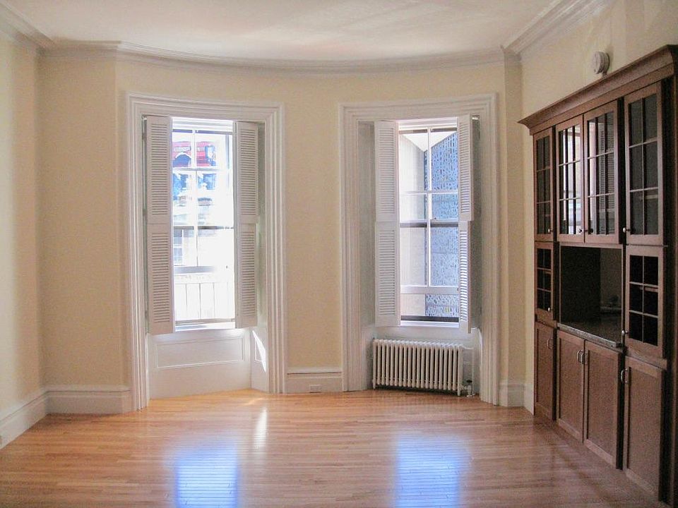 Windows looking over the Marlboro Street church. Kitchen pass through and storage on the right. Many tenants set up a dining area in the bay.